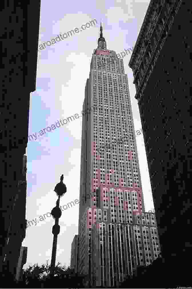 Close Up Of The Iconic Empire State Building, Towering Over Midtown Manhattan With Its Distinctive Art Deco Design And Illuminated Spire. The Architecture Of New York City: Histories And Views Of Important Structures Sites And Symbols